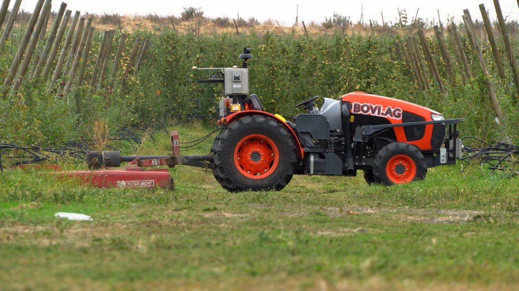 BOVI remote-capable tractor mowing in an orchard